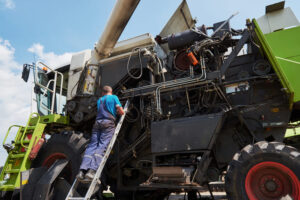 Técnico realiza manutenção em uma máquina agrícola.